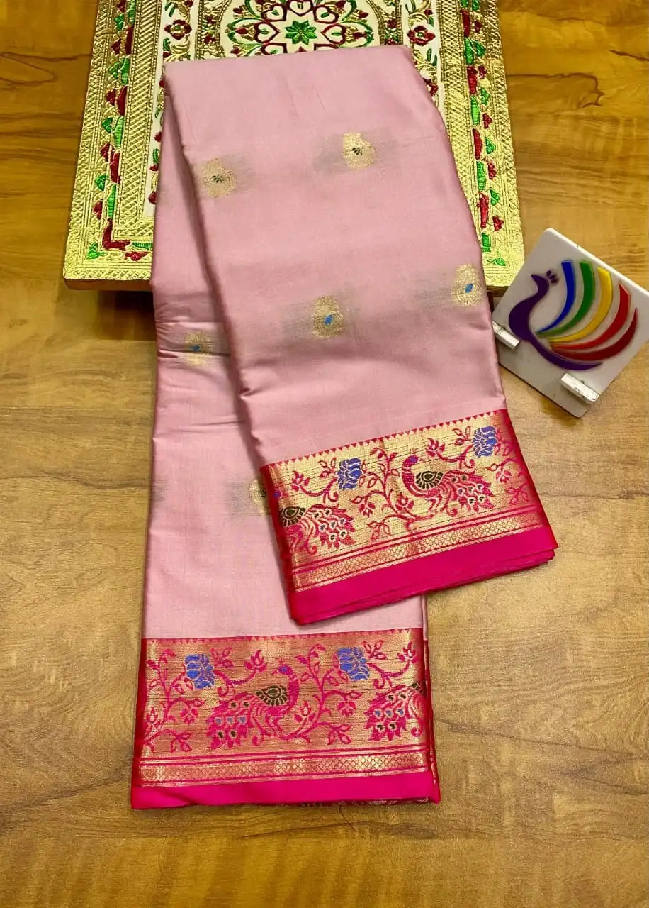 Pale pink Paithani saree folded, rani pink peacock border and zari bootis on the body