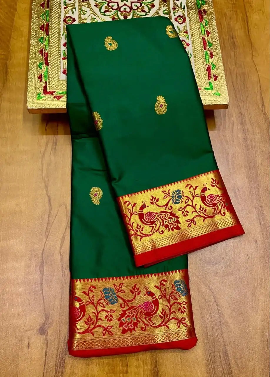 Bottle green Paithani saree folded, red border woven with gold peacock and floral motifs