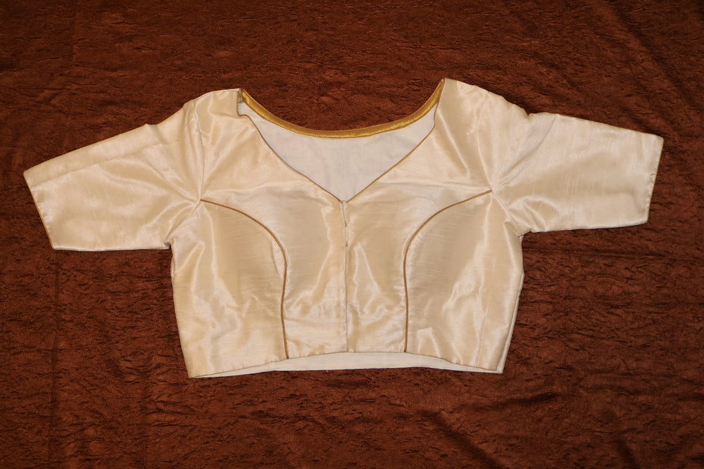 Cream silk blouse front laid flat, V neckline and elbow-length sleeves