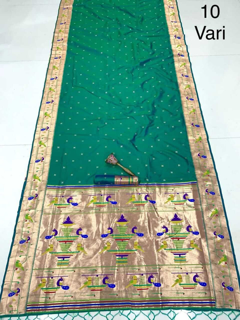 Sea green saree laid out flat, zari border with peacocks and a broad gold motif pallu