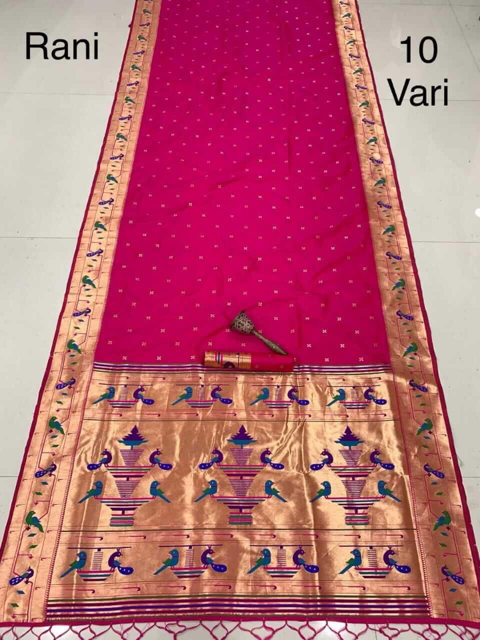 Rani pink saree spread flat, gold tissue pallu with peacock and vase weave, marked 10 Vari