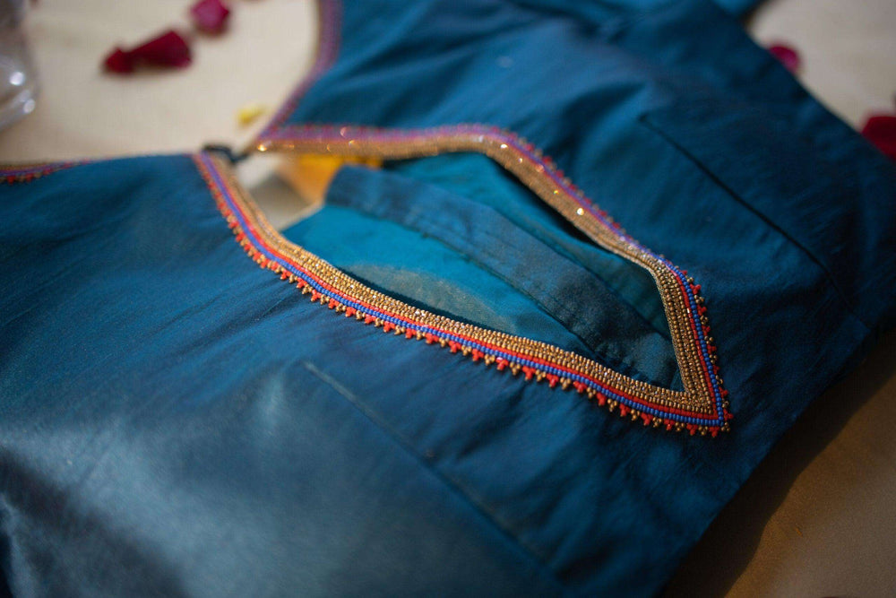 Close-up of the beaded trim outlining the blouse's leaf-shaped back opening
