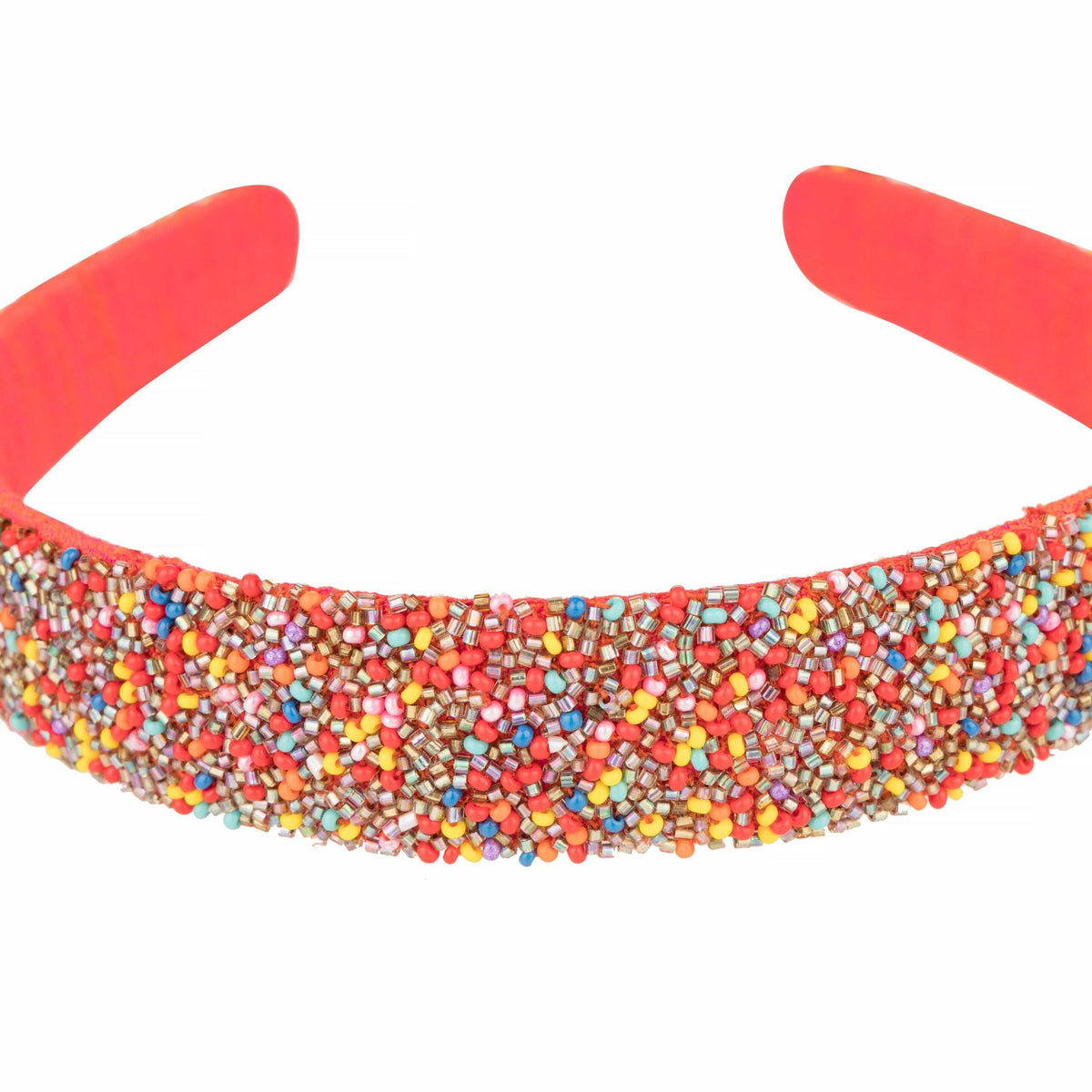 Close-up of the multicolour seed beads packed across the headband's coral padded band