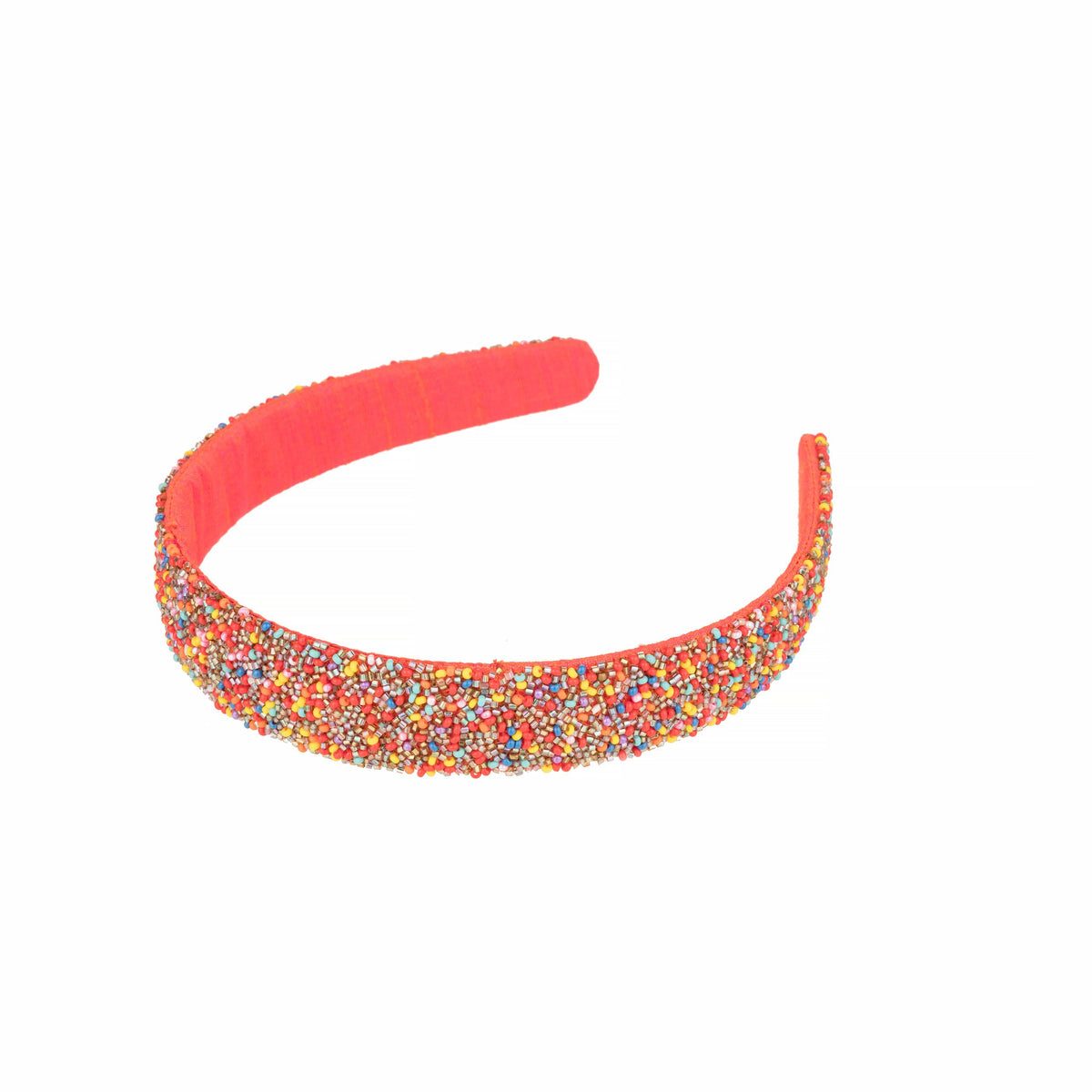Beaded headband at an angle, showing the coral fabric-wrapped arch behind the beadwork