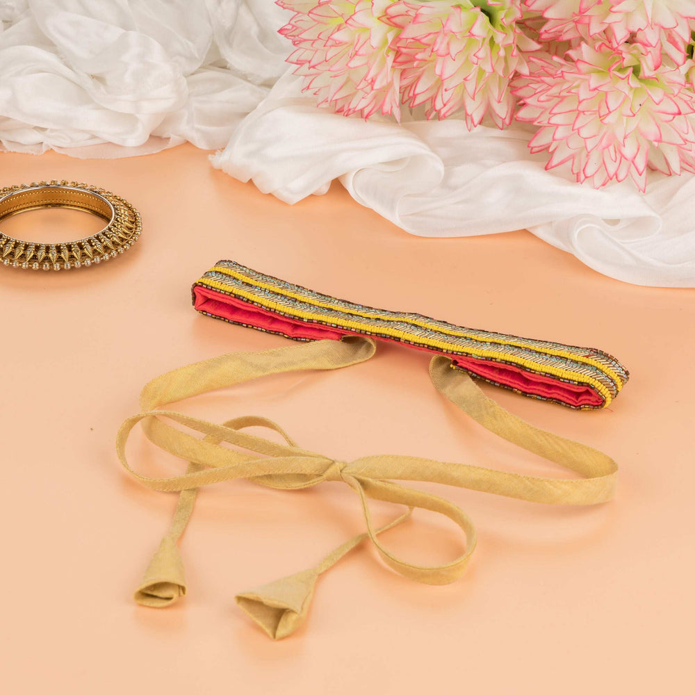 Neon yellow saree belt styled on peach with dahlias, its ties trailing loose