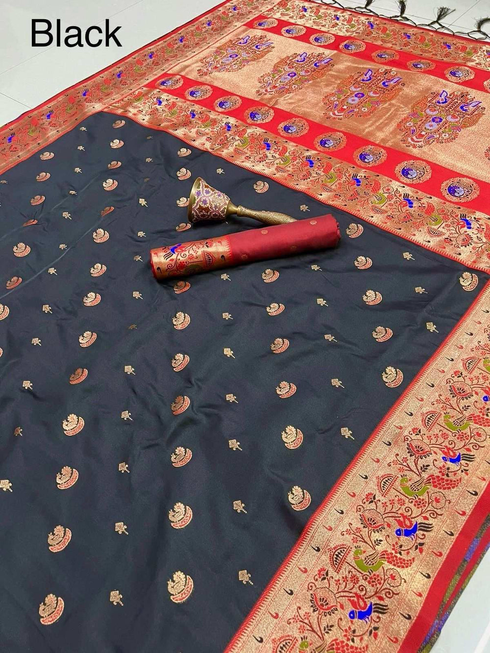 Black Paithani saree with red peacock border and rolled blouse piece on top