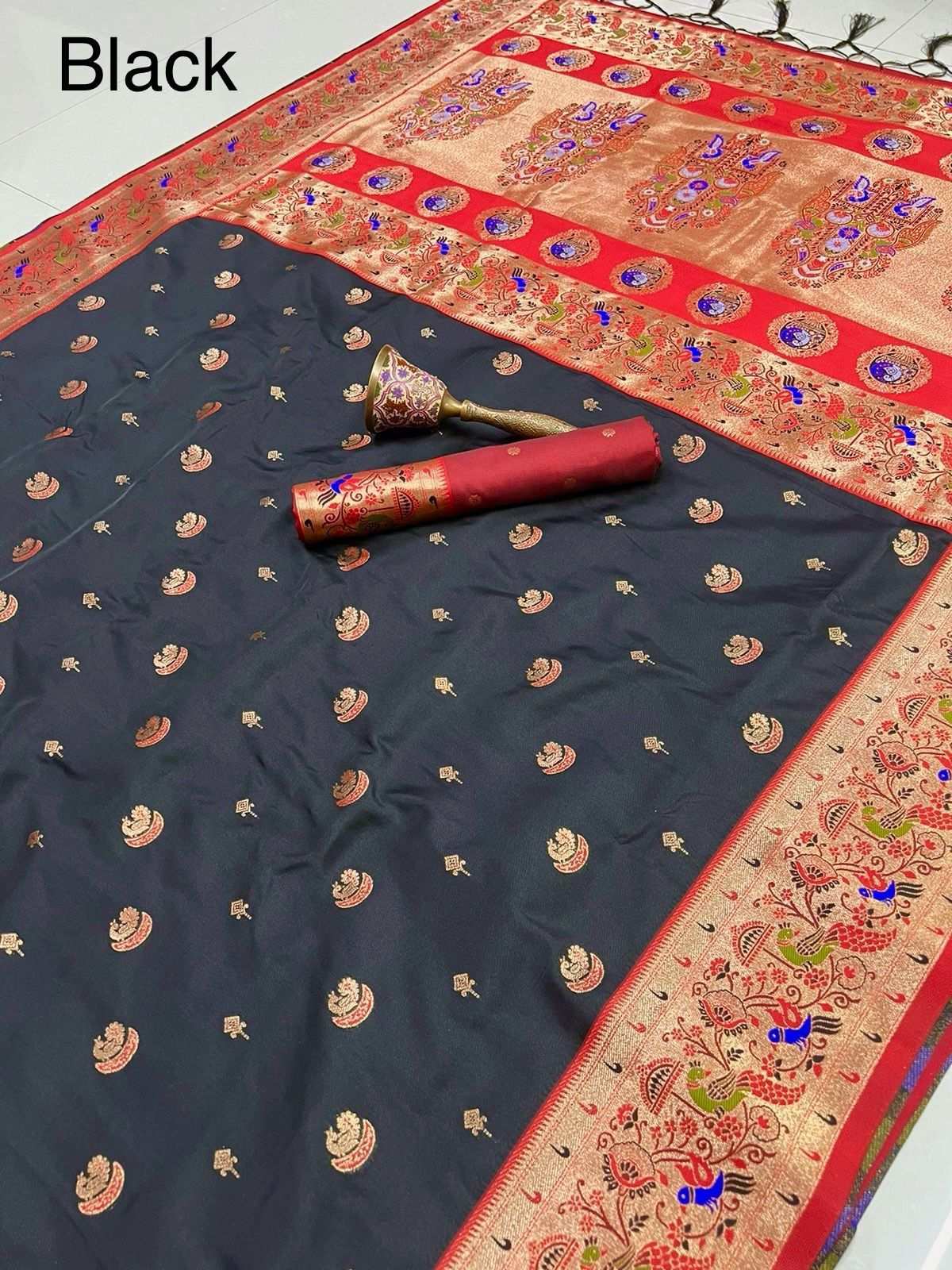 Black Paithani saree with red peacock border and rolled blouse piece on top