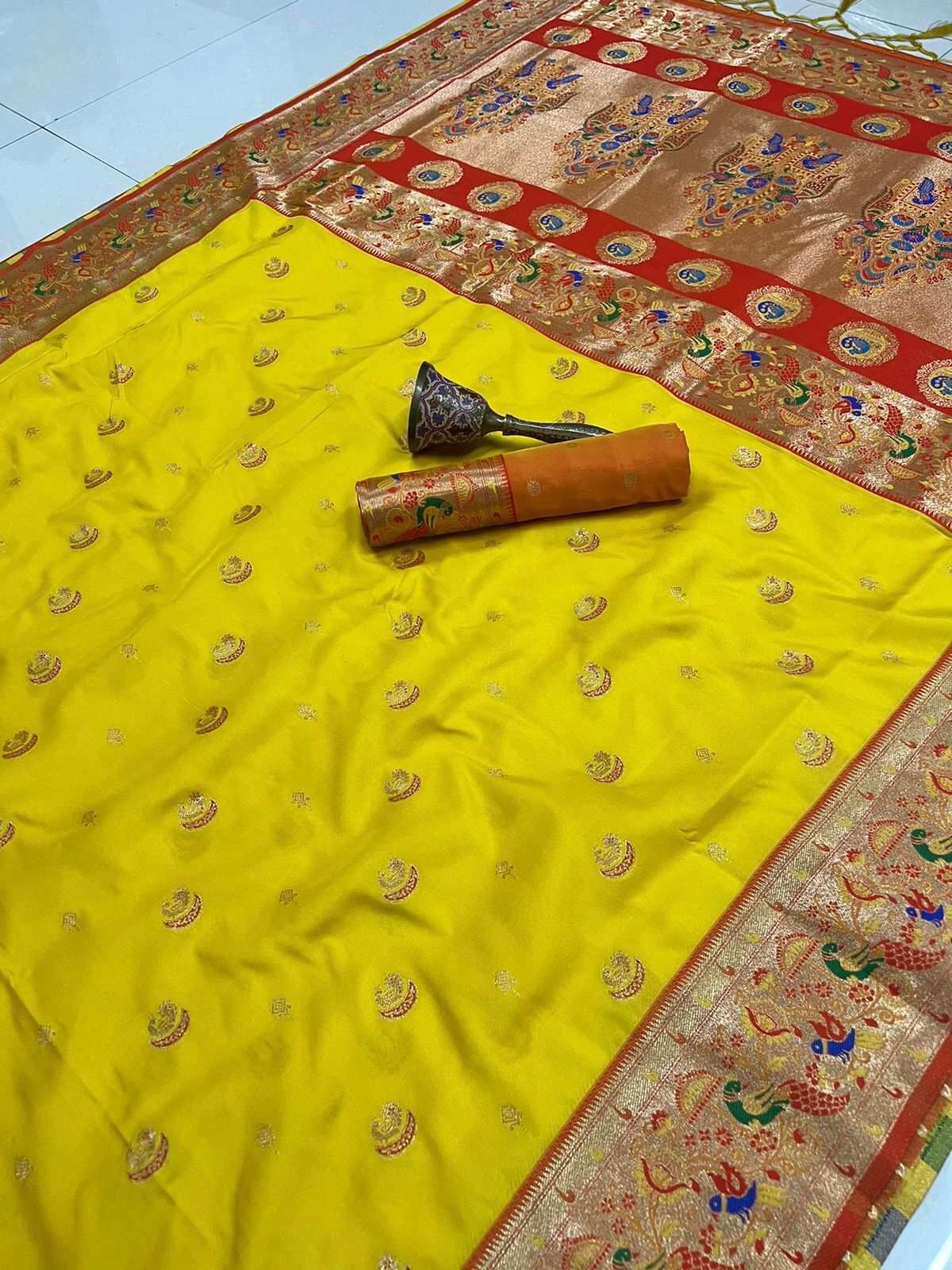 Yellow body with red peacock-and-floral border on this Paithani saree