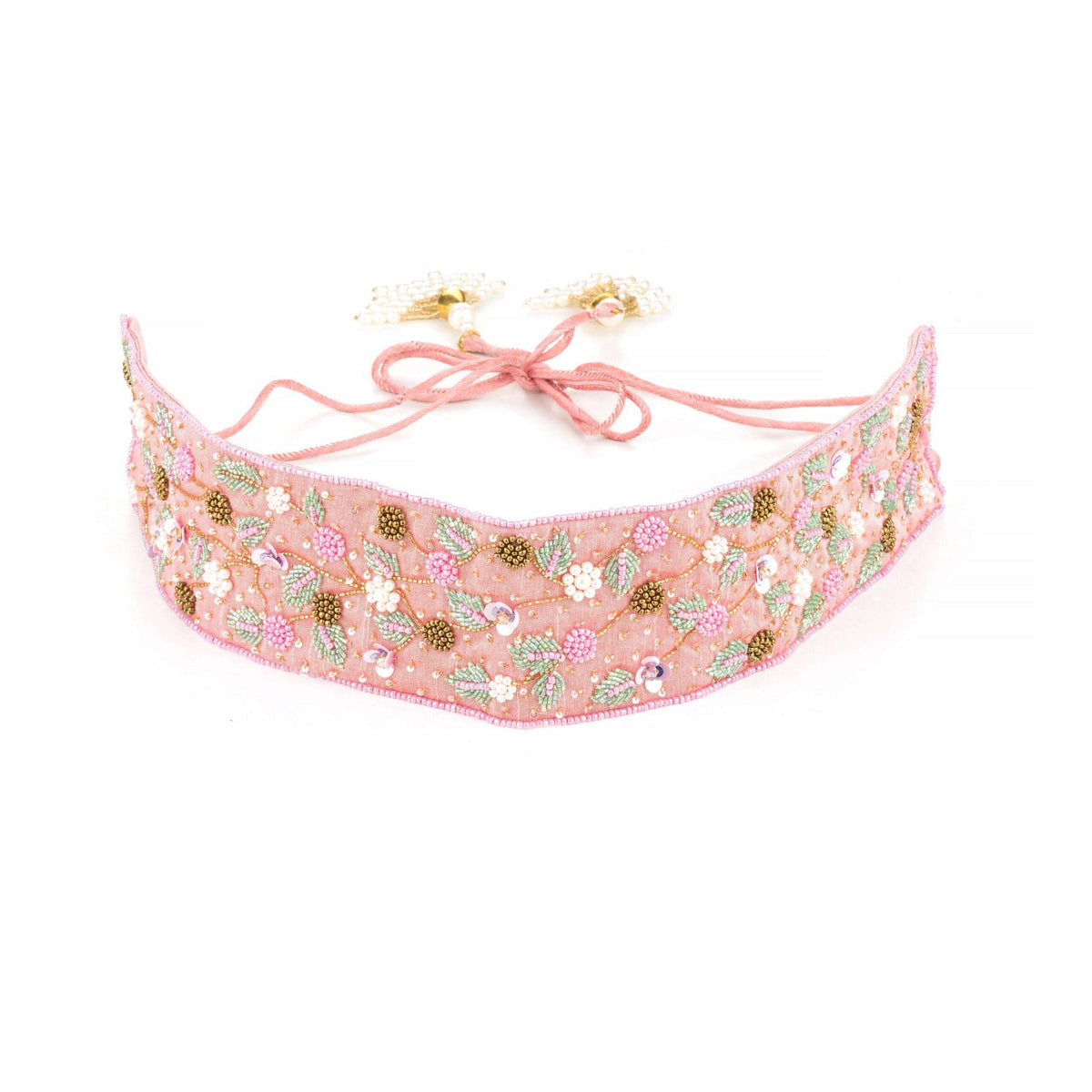 Pink beaded saree belt curved on white, tie cords with pearl cluster tassels laid above