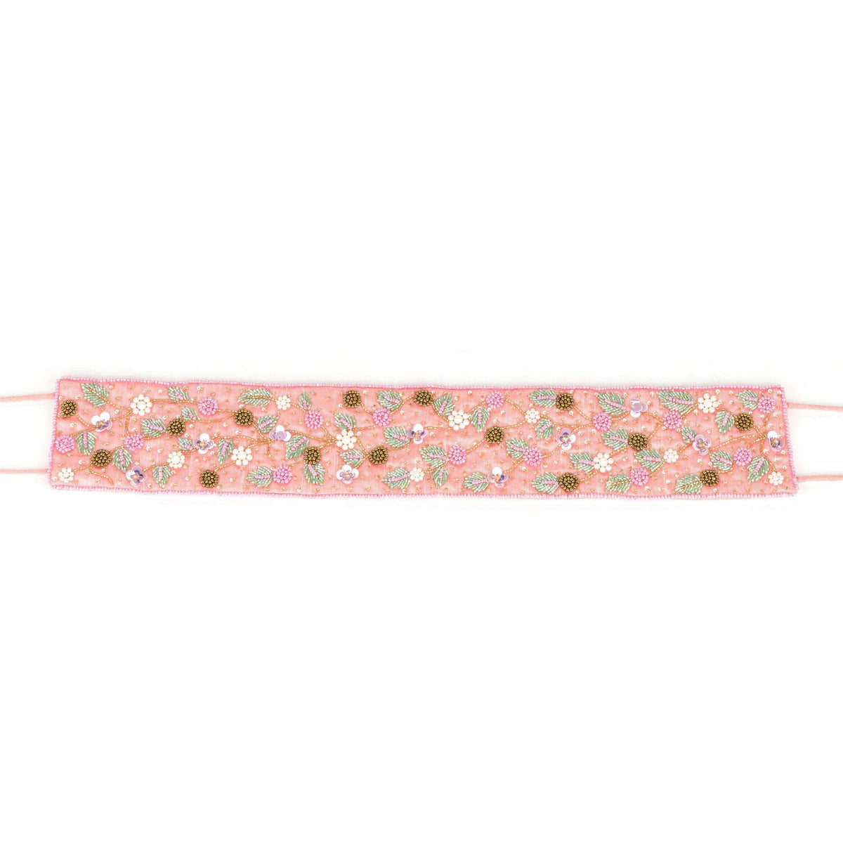 Full length of the floral beaded saree belt stretched flat with its pink ties out to the sides
