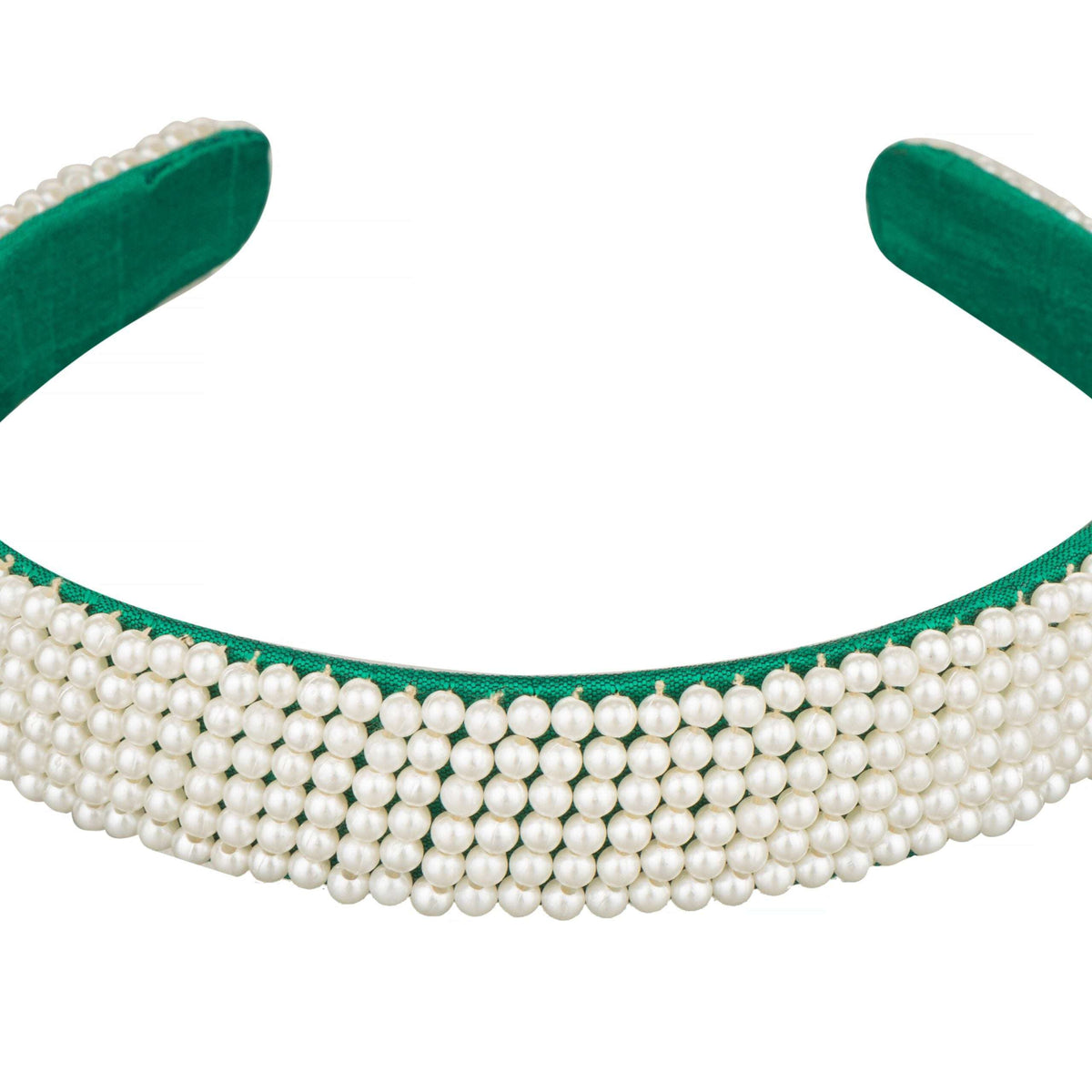 Close-up of the tightly packed pearl rows stitched onto the green headband