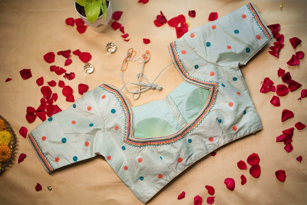 Back of the mint blouse showing the deep cut-out and dori tie strings