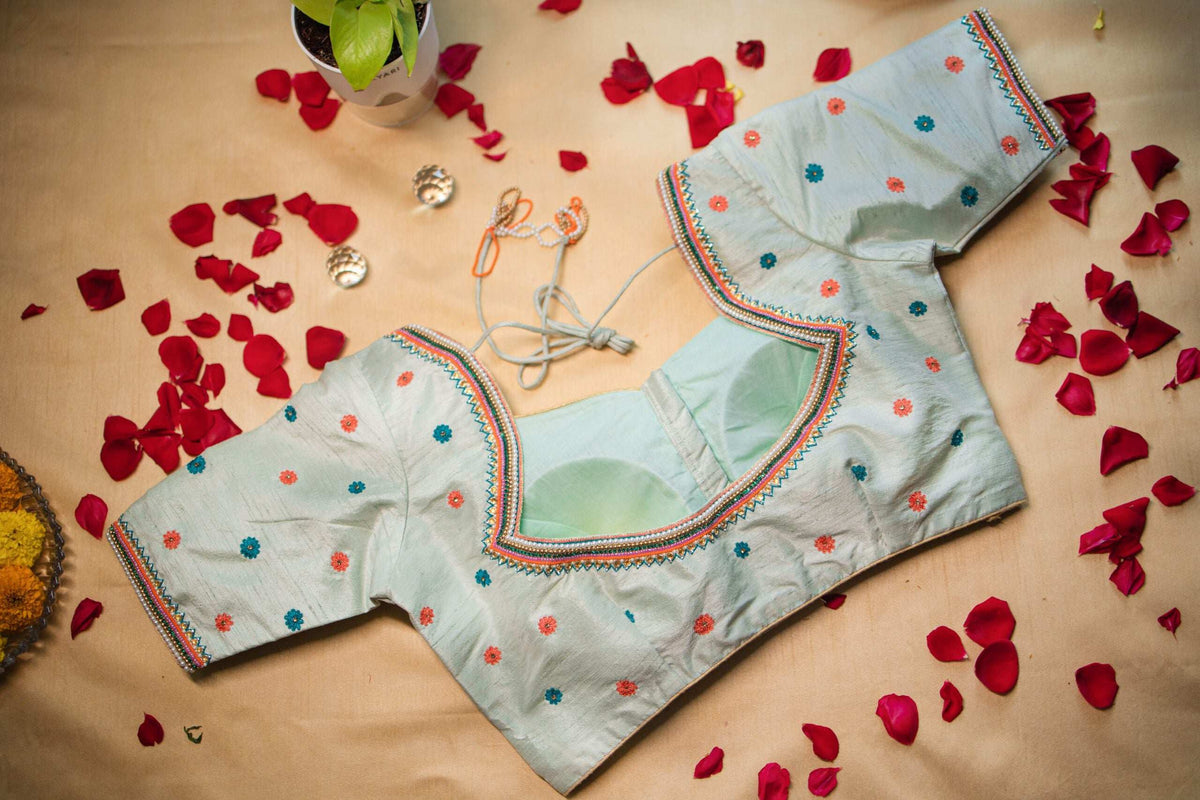 Back of the mint blouse showing the deep cut-out and dori tie strings