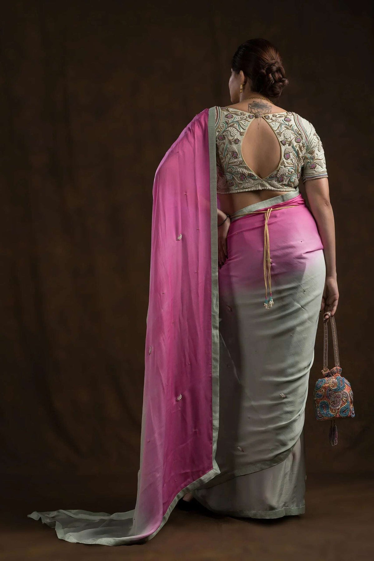Pistachio embroidered blouse worn with a pink and mint ombre saree, full back view