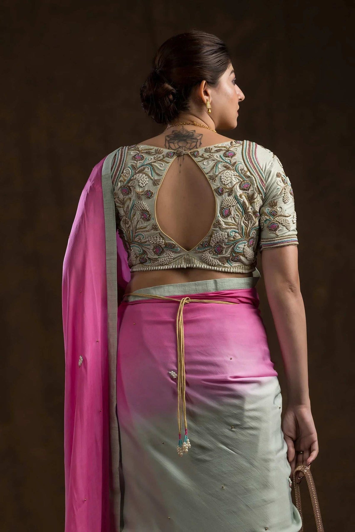 Keyhole back of the blouse with gold dori tassels hanging at the waist