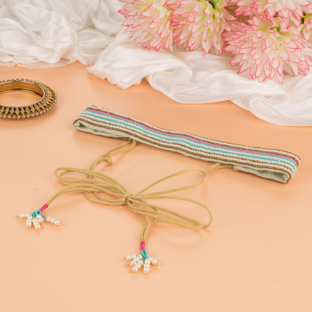 Striped saree belt in gold, teal and mauve laid flat with its tie cords