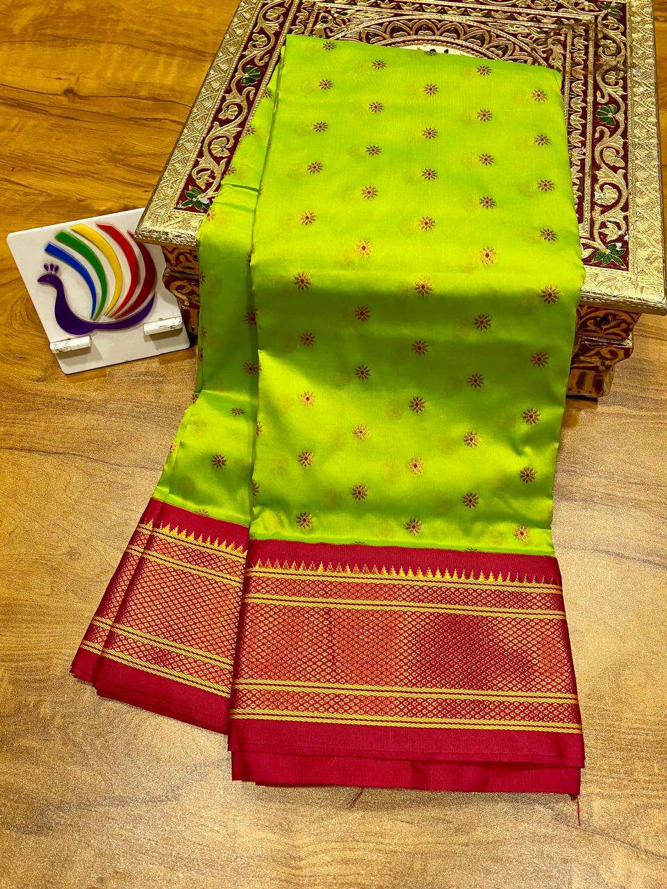 Parrot green body with fine bootis, contrast red kadiyal border in gold zari