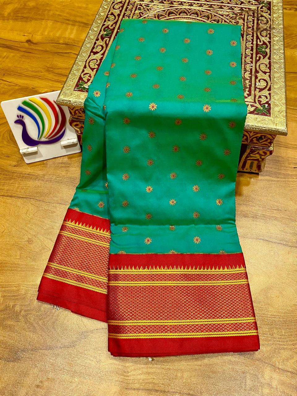Rama green colour option, red border joined kadiyal-style to the booti-covered body