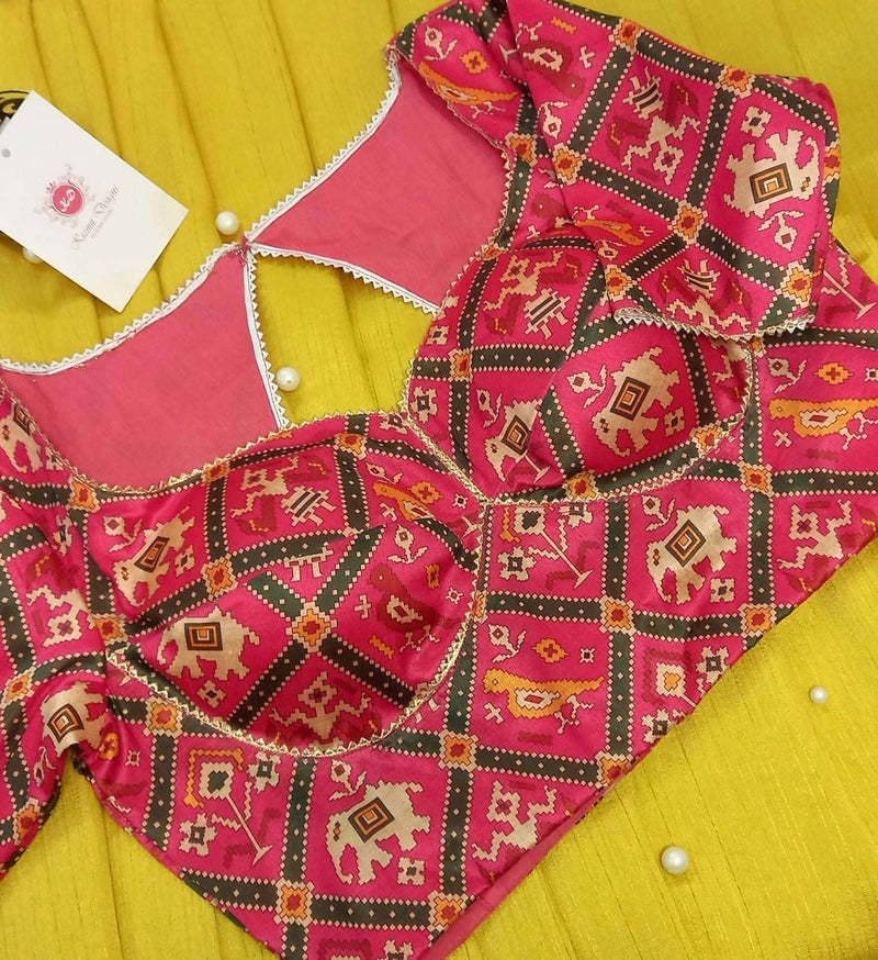 Rani pink patola print blouse with elephant and parrot motifs, flat lay from above