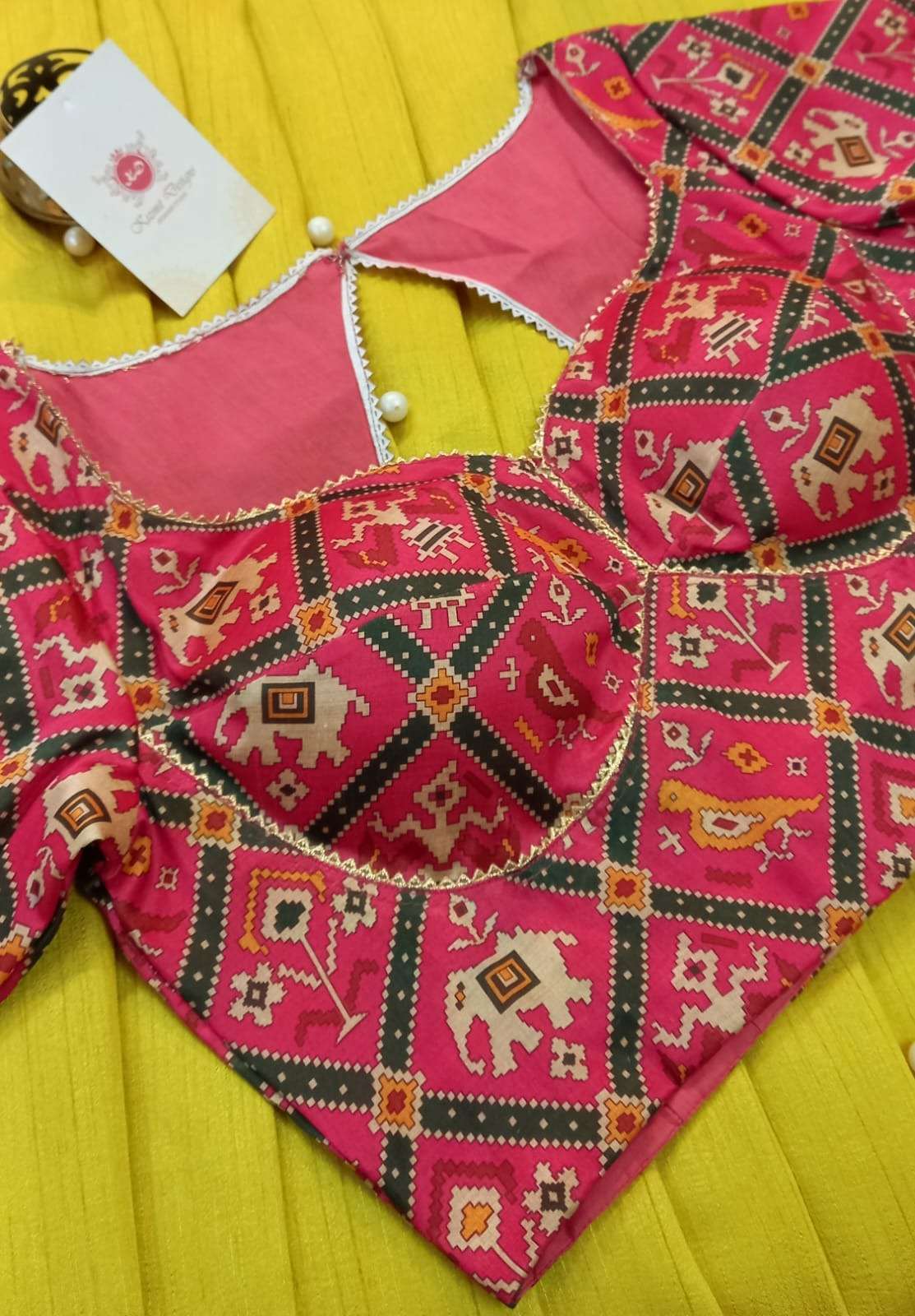 Close-up of the lace-edged neckline and back opening on the patola blouse