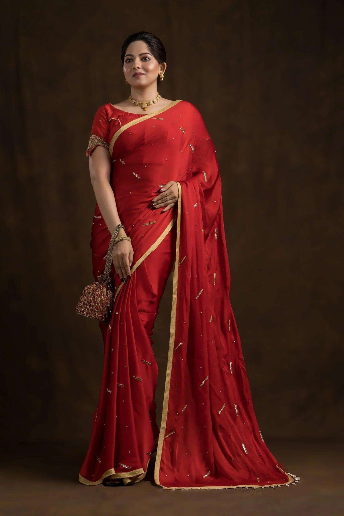Red mayur blouse worn with a red saree and gold border, full-length front view