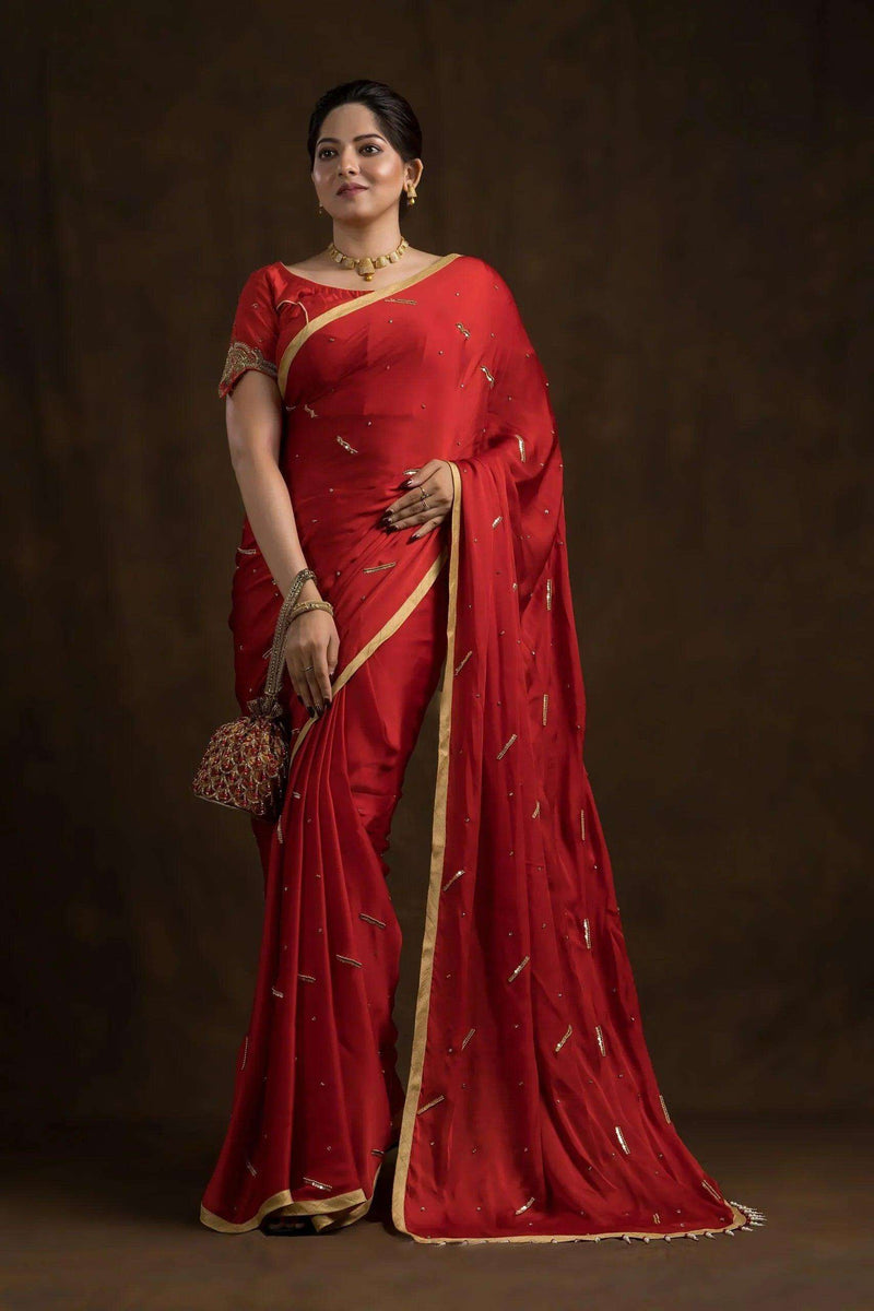 Red mayur blouse worn with a red saree and gold border, full-length front view
