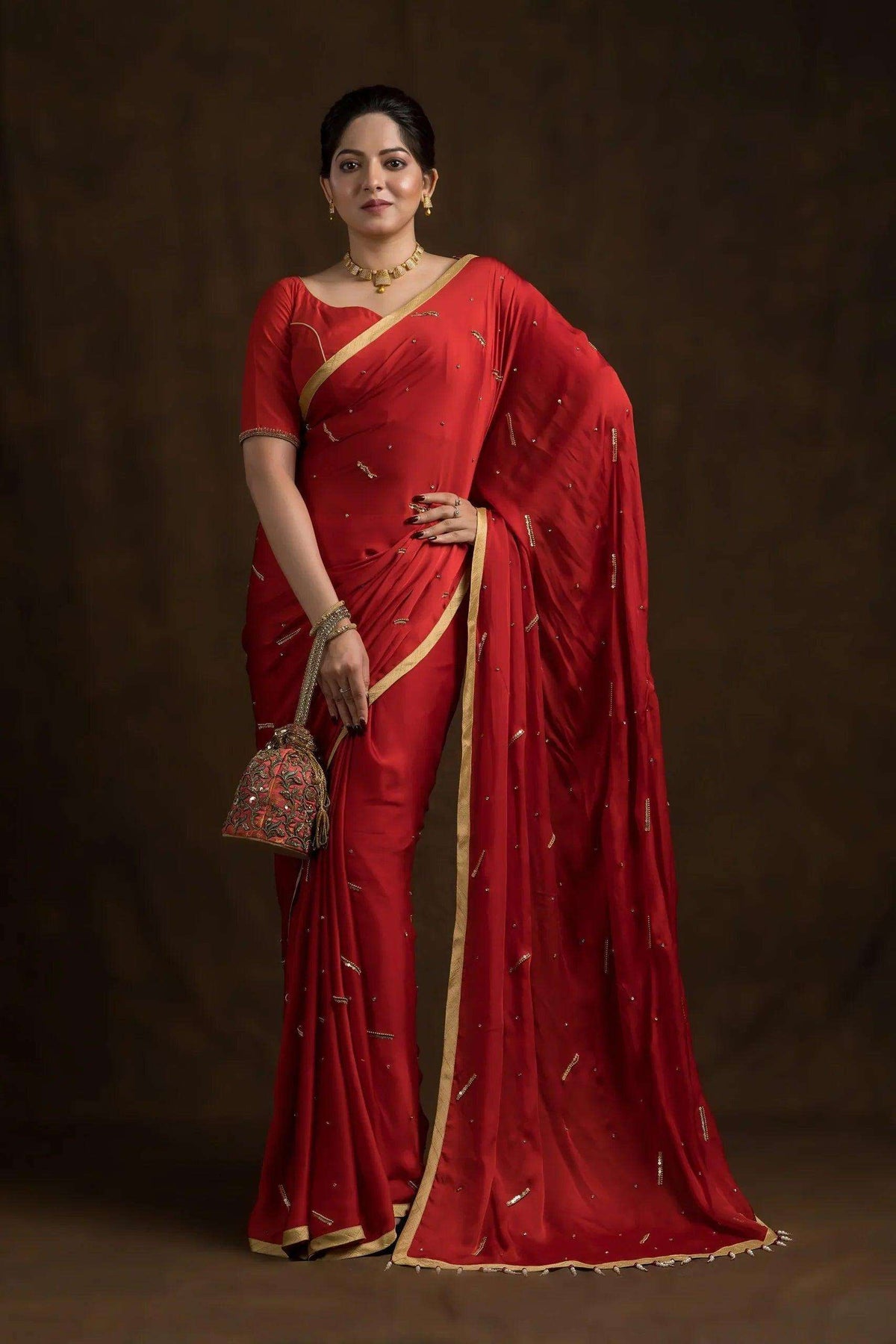 Red chand ka tukda blouse worn with a red and gold saree, front view