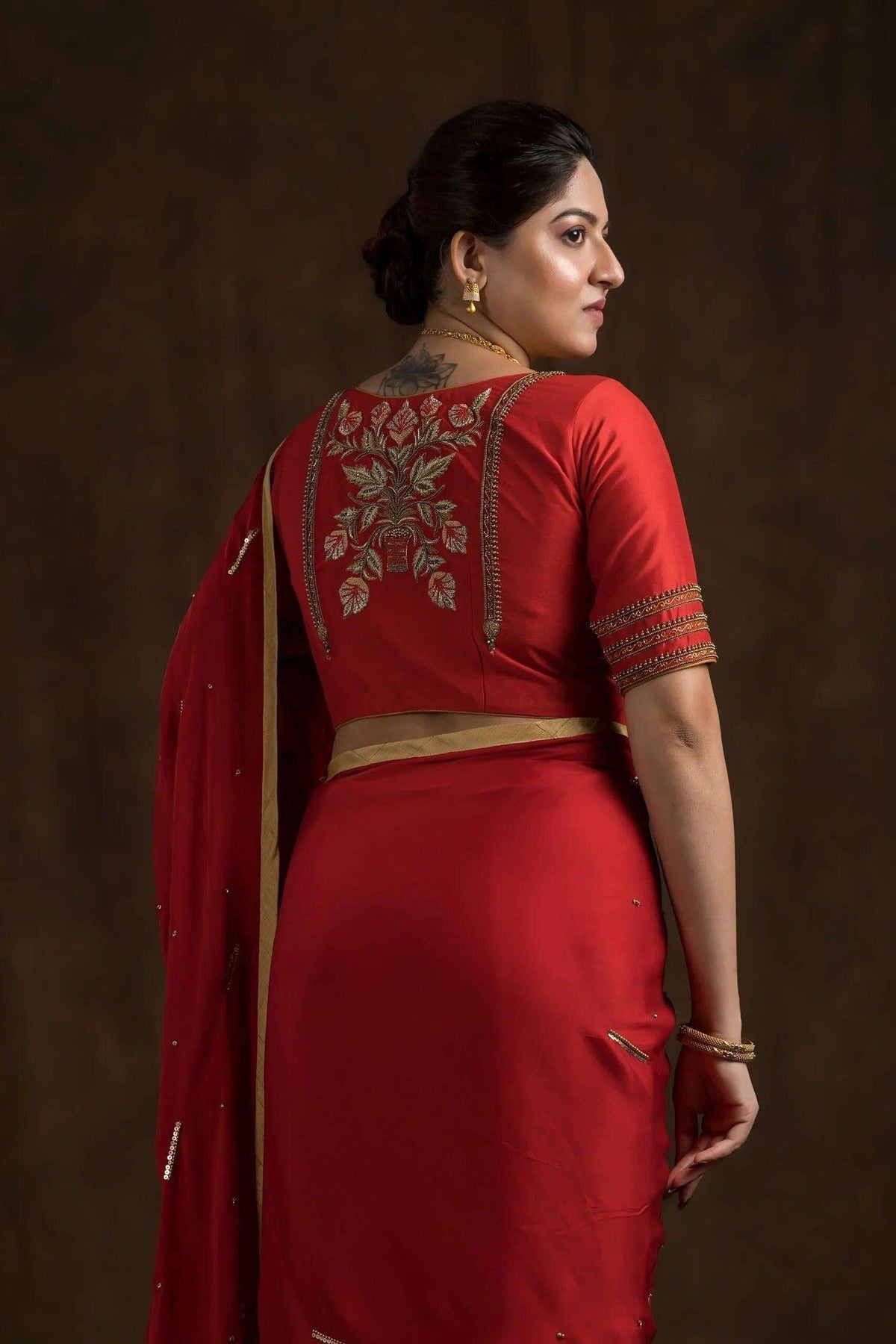 Mughal floral motif embroidered in gold on the red blouse back, close back view