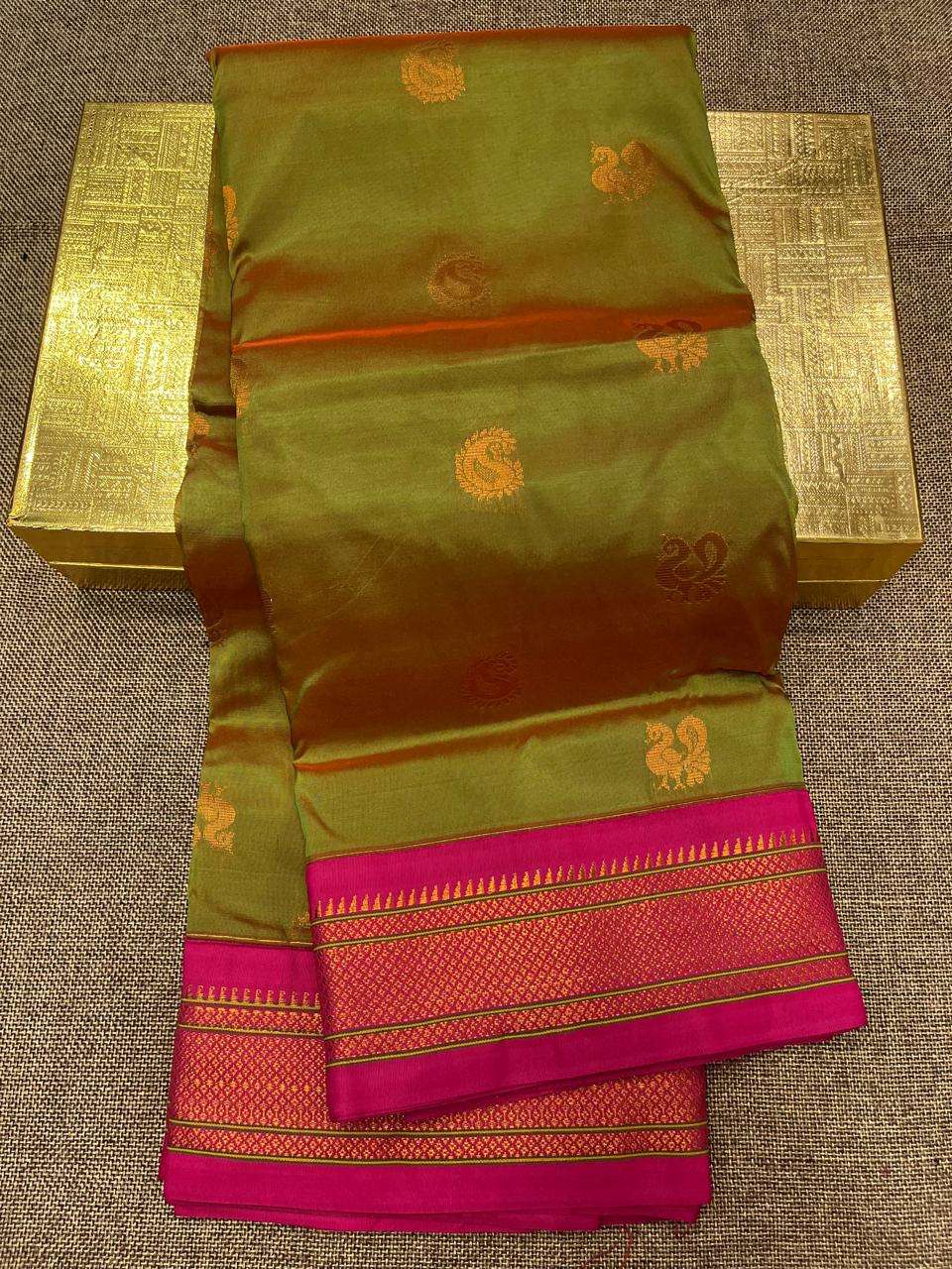 Olive and rust semi Paithani saree with gold peacock bootis and rani pink border