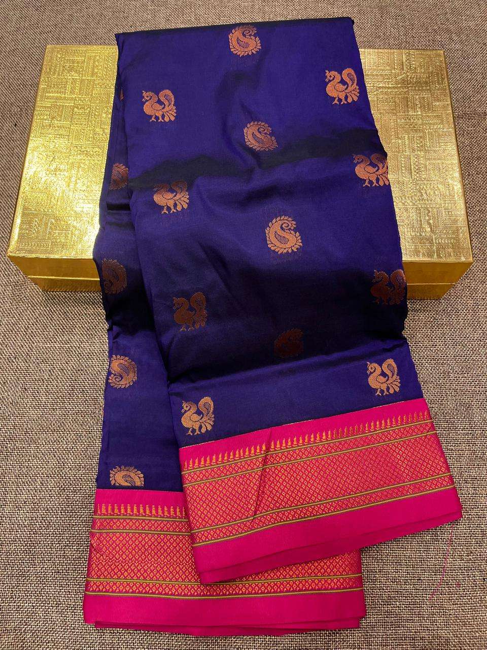 Navy blue Paithani saree with copper peacock bootis and a bright pink brocade border