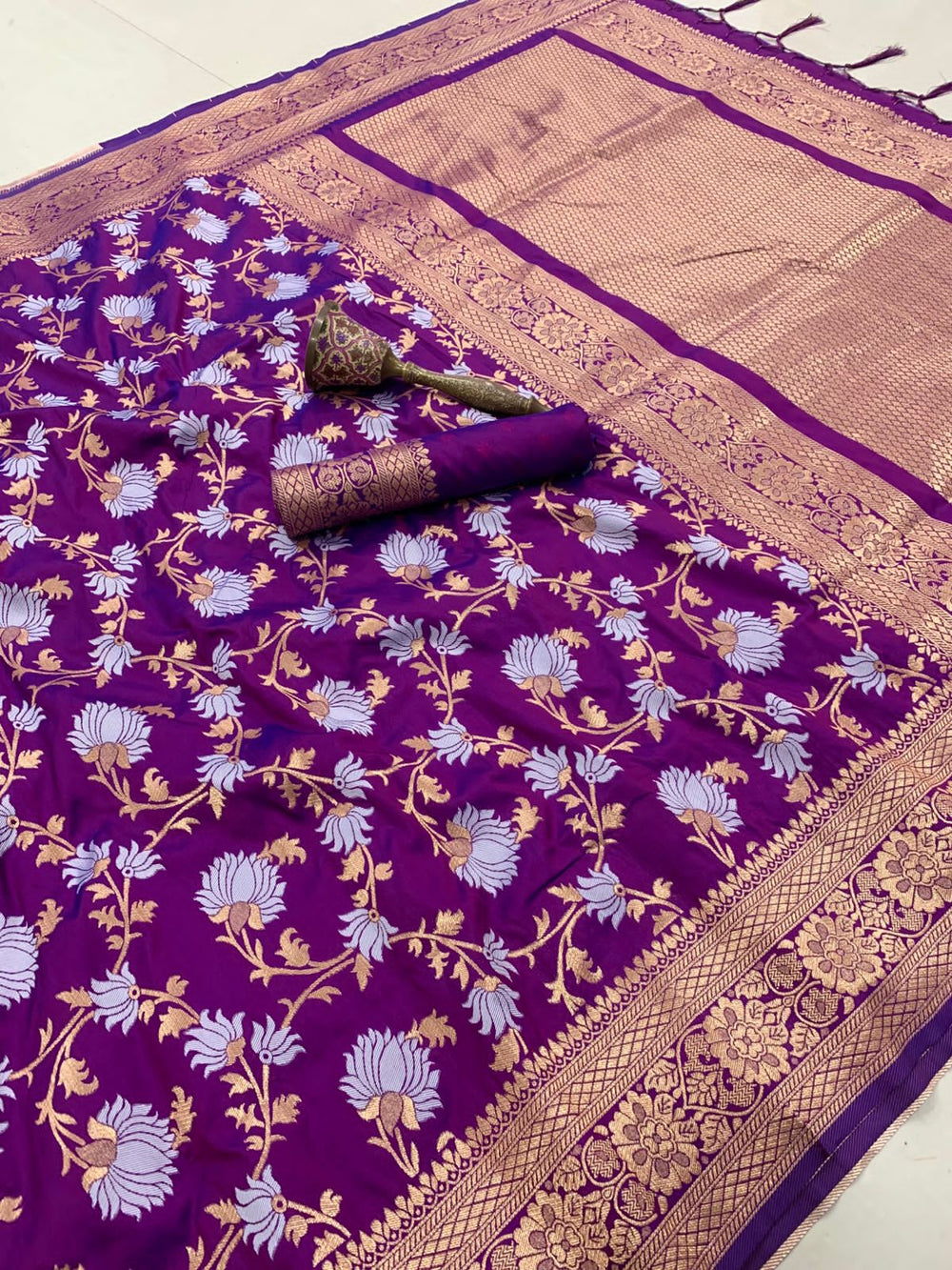 Purple saree spread flat with lavender and gold floral jaal and matching blouse piece