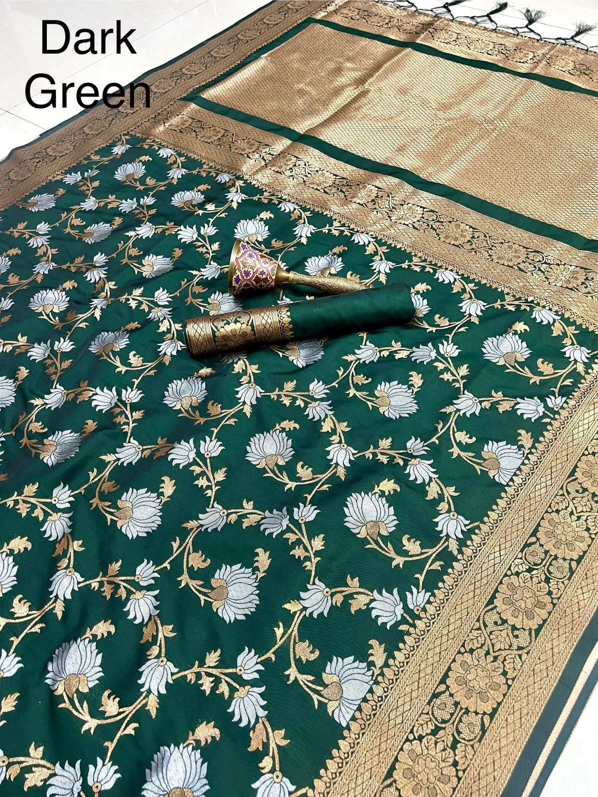Dark green colourway of the designer saree in flat lay, labelled Dark Green