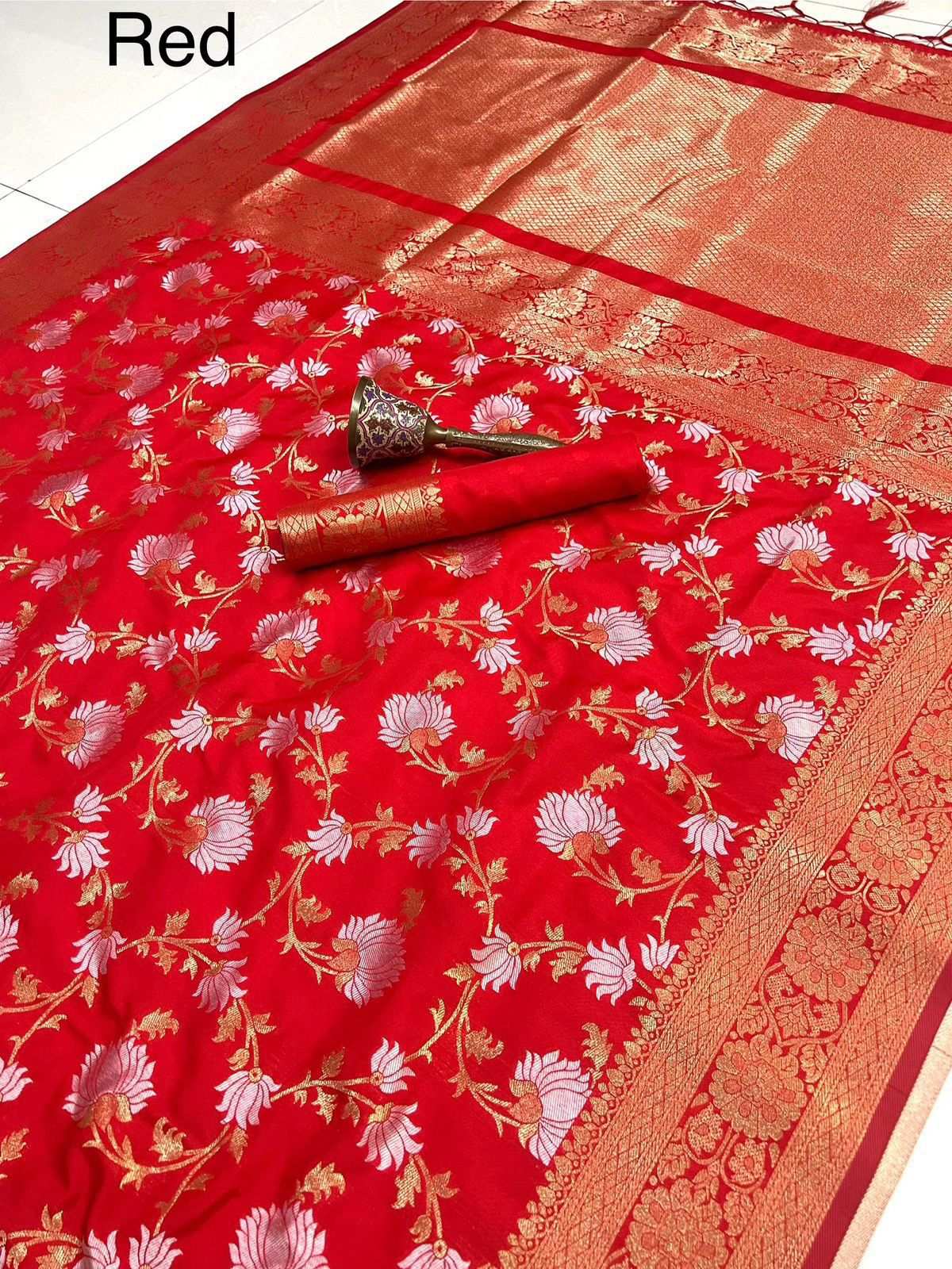 Red colourway laid flat with white floral jaal and wide zari border, labelled Red