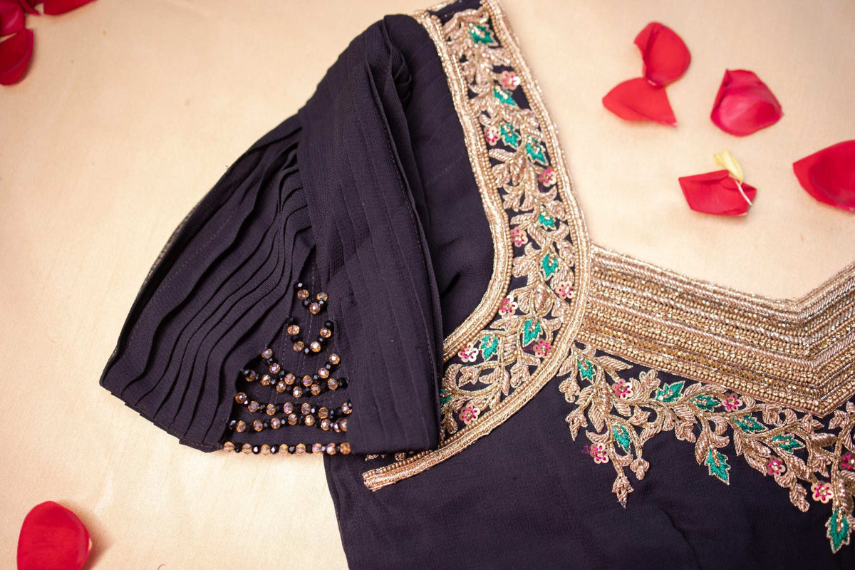 Pleated puff sleeve with hanging bead tassels beside the embroidered neckline