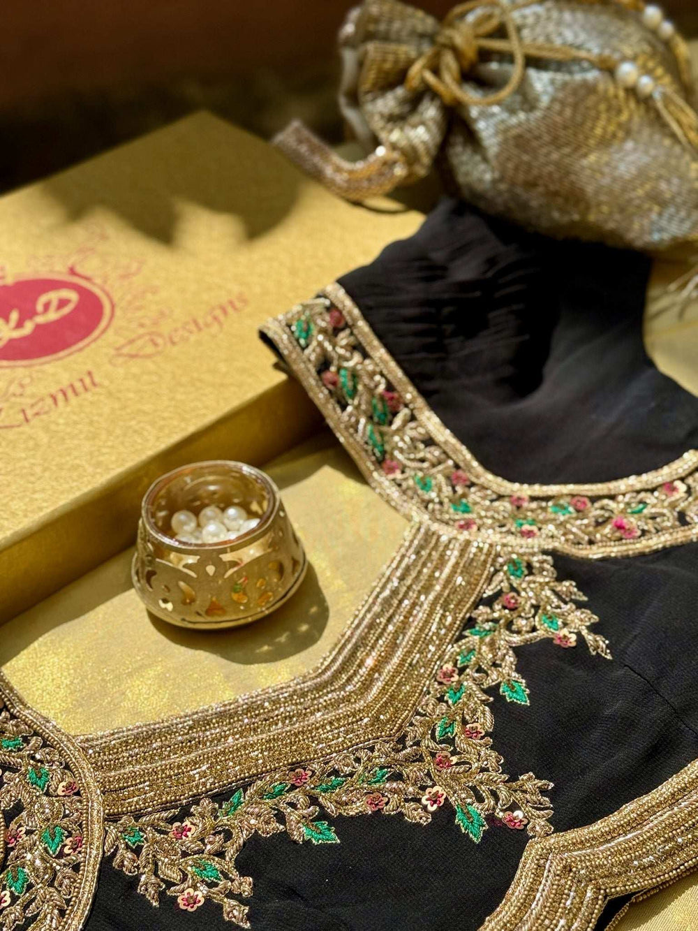 Blouse styled with a gold Kizmit Designs gift box, potli bag and tealight holder