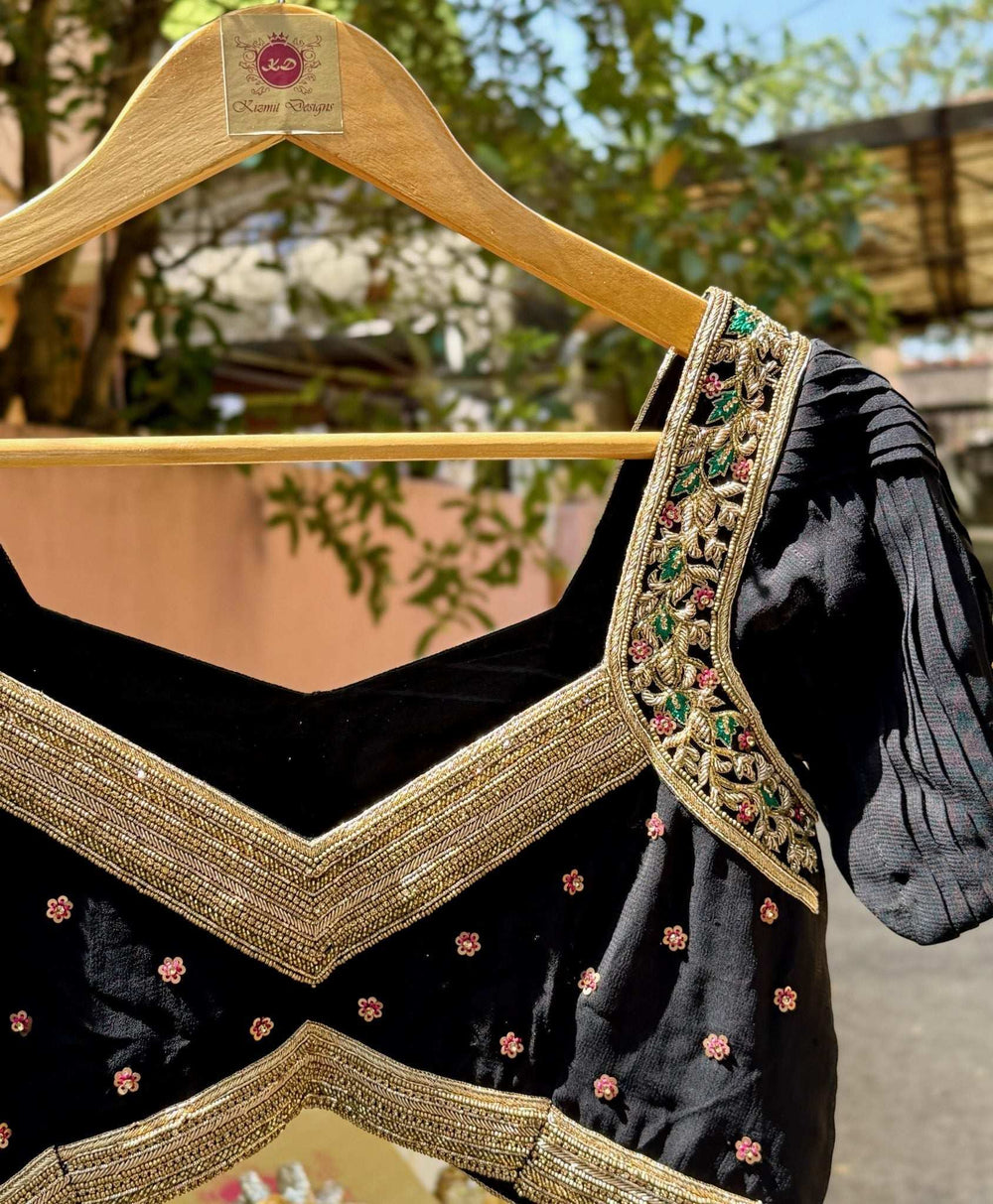 On a wooden hanger outdoors, showing the V waist border and embroidered sleeve cap