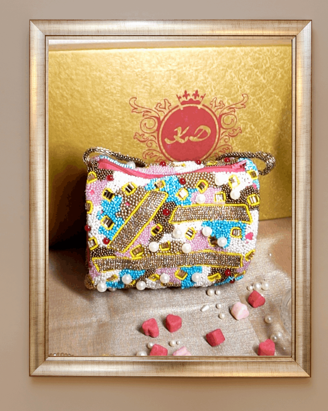 SHRIA mosaic sling bag in multicoloured beadwork, framed against a gold Kizmit backdrop