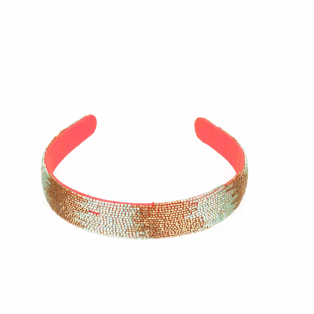 Full length of the headband on white, showing the coral inner band and beaded outer face