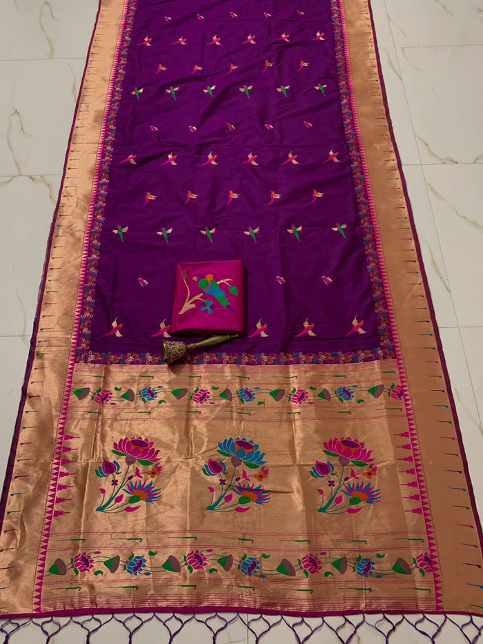 Violet body with muniya bootis and a wide gold zari lotus pallu