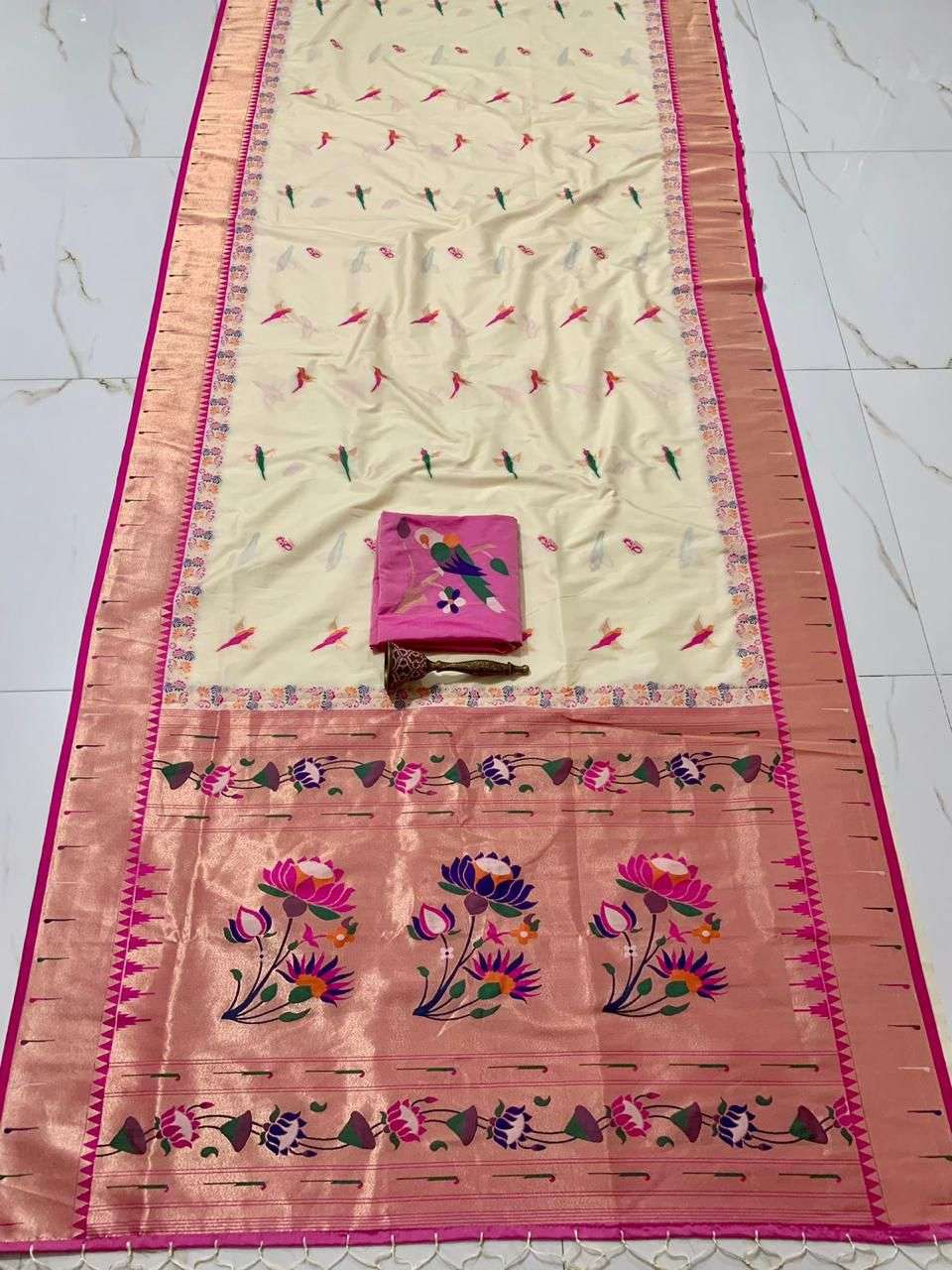 Cream body and rani pink border on this single muniya Paithani saree