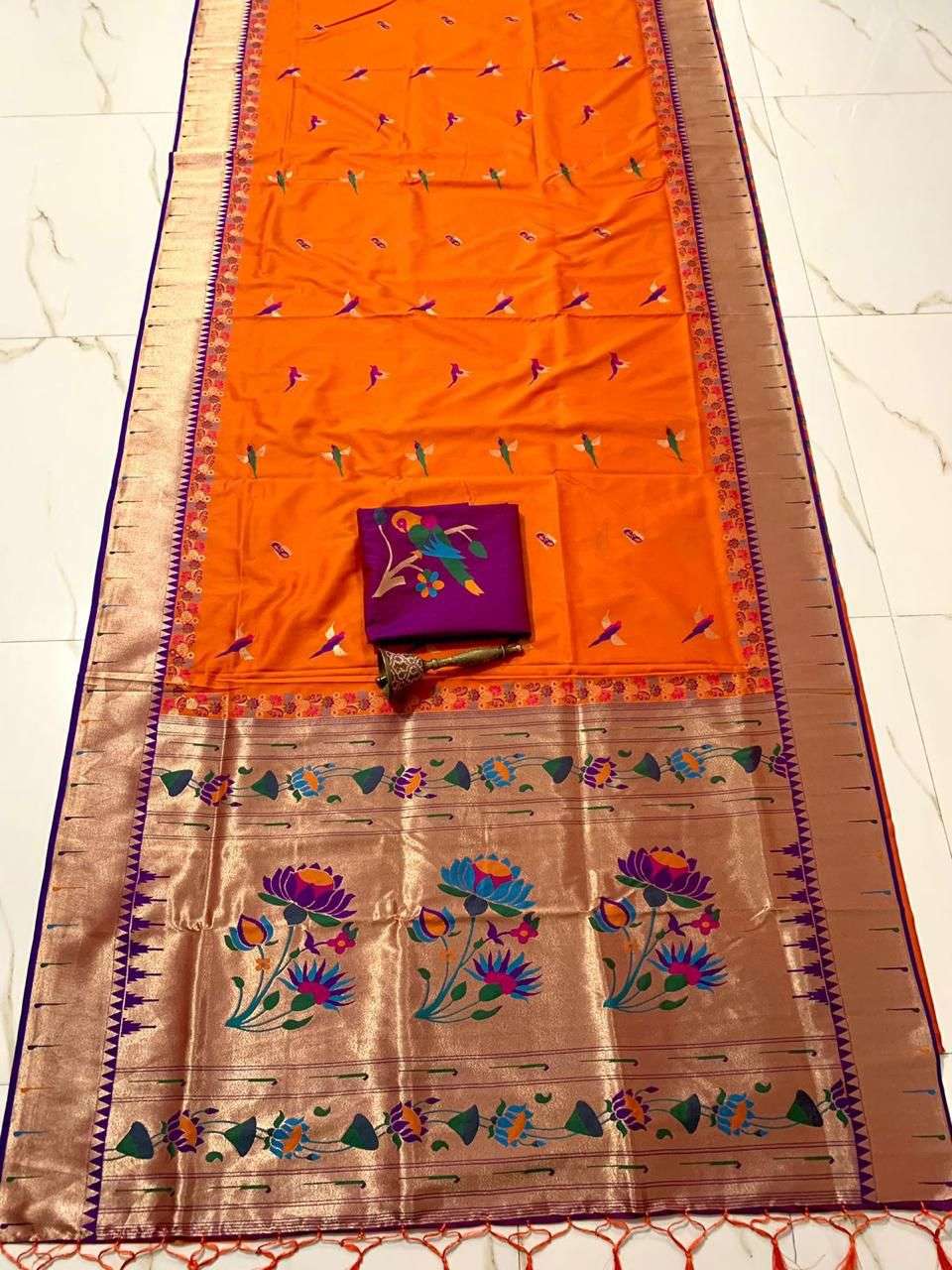 Orange body with purple border and muniya bootis, folded flat-lay