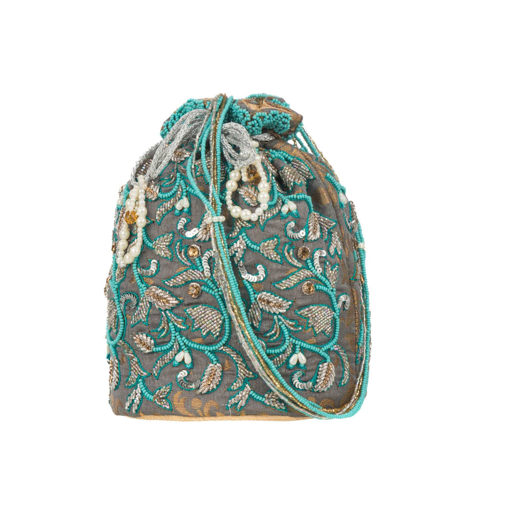 Front of the bag showing zari leaves and scattered sequins on a grey ground