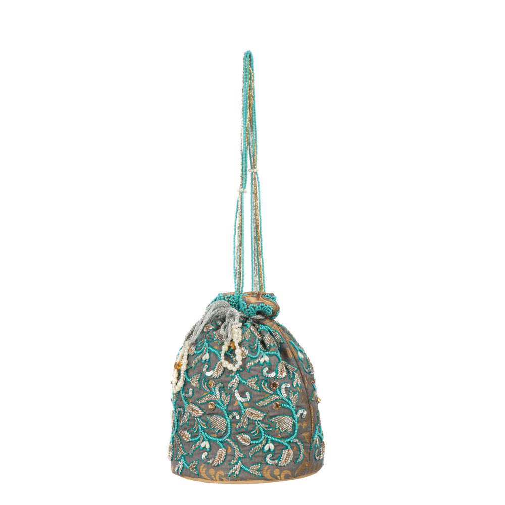 Full height with the long turquoise beaded handle extended above the bag