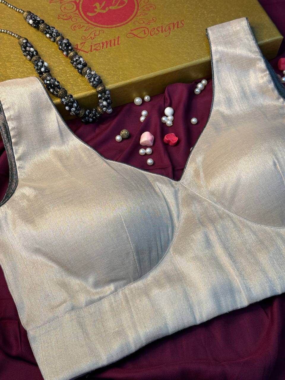 Close view of the padded cups and piped round neckline in shimmering ivory tissue