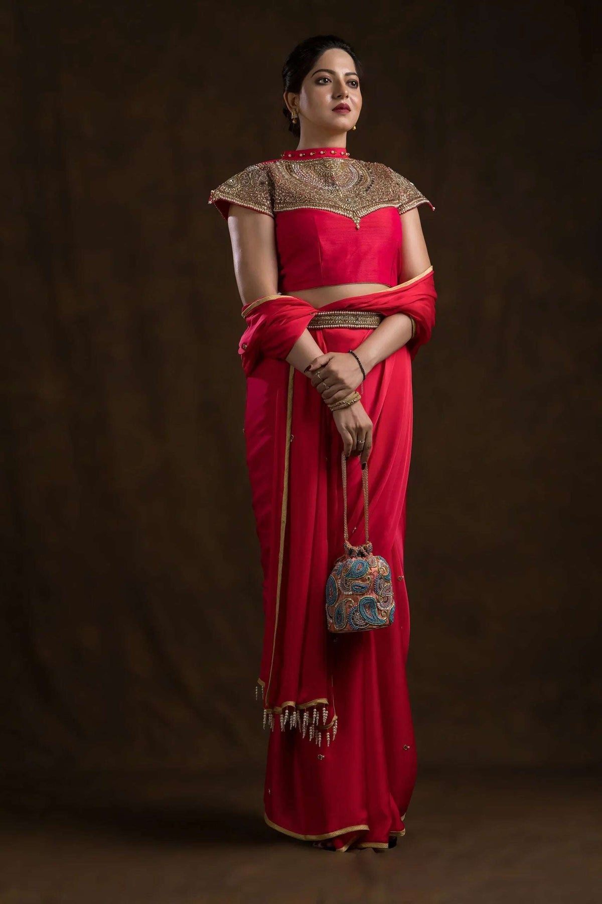 Model in a deep pink choker blouse and draped pink saree, full-length front view