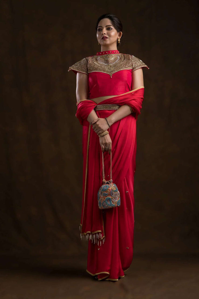 Choker blouse worn with a pink saree and embellished waist belt, standing pose