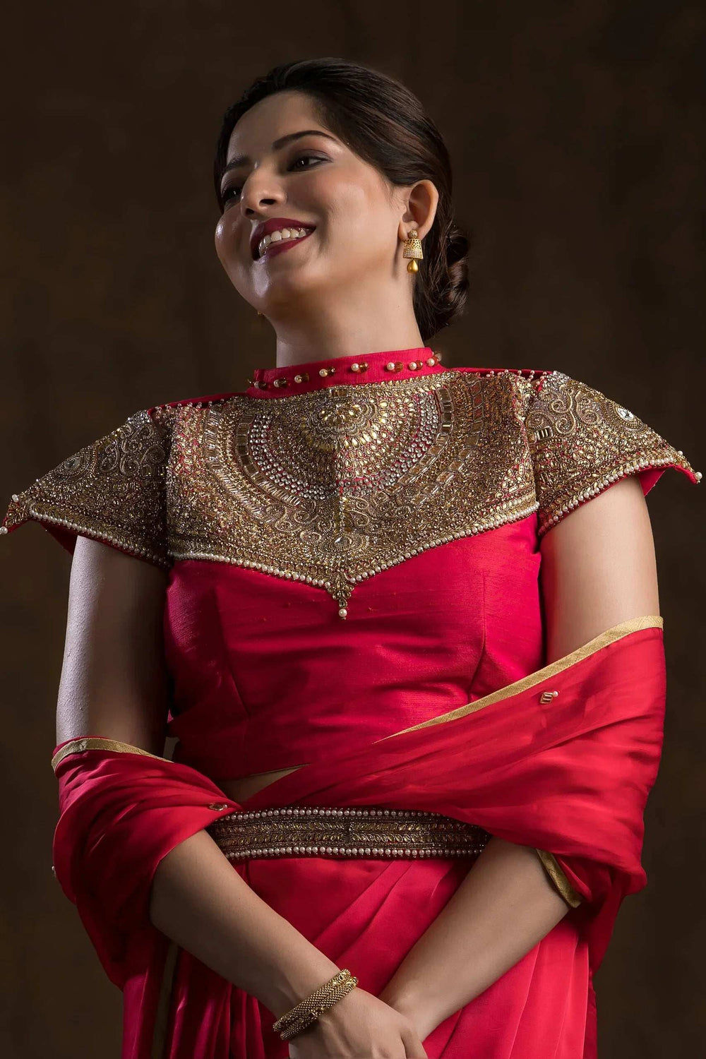 Close-up of the mirror and zari work across the choker yoke and cap sleeves